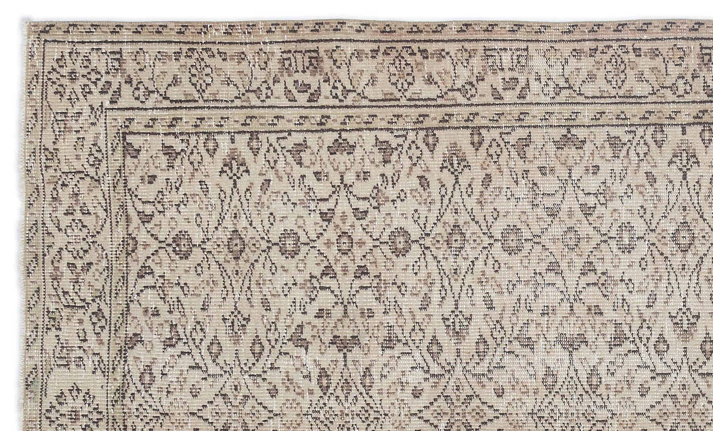 Beige and brown distressed rug with a traditional floral trellis pattern and a decorative border.