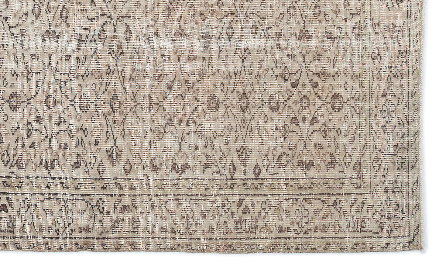 Beige and taupe distressed rug with a traditional floral medallion pattern and a detailed border.