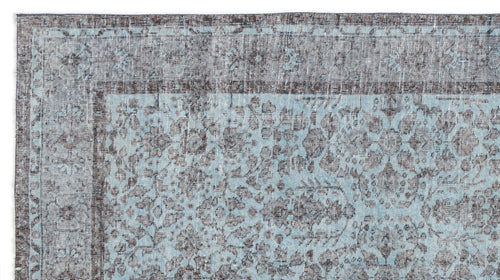 Load image 1 in gallery view. Distressed light blue and charcoal grey rug with a traditional floral medallion pattern and a wide border.