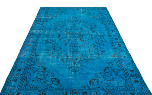 Load image 1 in gallery view. Bright blue vintage-style rug with a distressed black floral medallion pattern and ornate border.