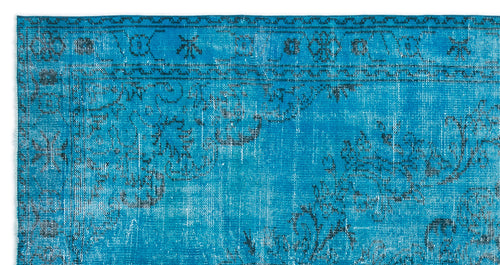 Load image 1 in gallery view. Bright blue distressed rug with a dark charcoal traditional floral medallion pattern and geometric border.