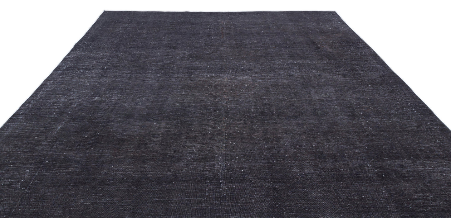 Solid charcoal black rug with a distressed, low-pile texture on a white background.
