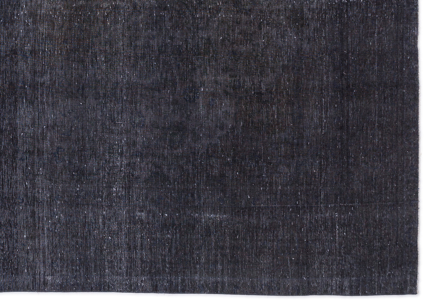 Solid charcoal black rug with a distressed, weathered texture and visible woven fiber details.