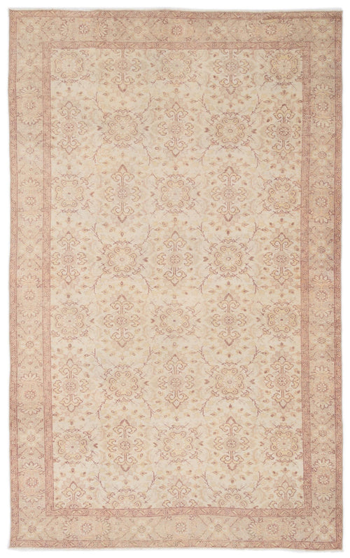 Load image 1 in gallery view. Beige and dusty rose traditional rug with a repeating floral medallion pattern and a bordered edge.
