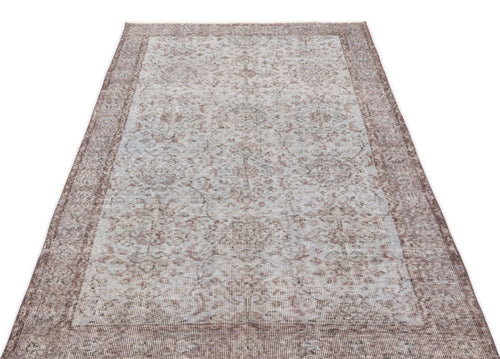Load image 1 in gallery view. Distressed light blue and brown traditional rug with a faded floral medallion pattern and a wide border.