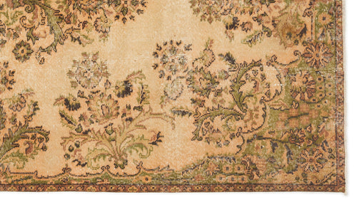 Load image 1 in gallery view. Distressed beige rug with a faded green and brown floral medallion pattern.