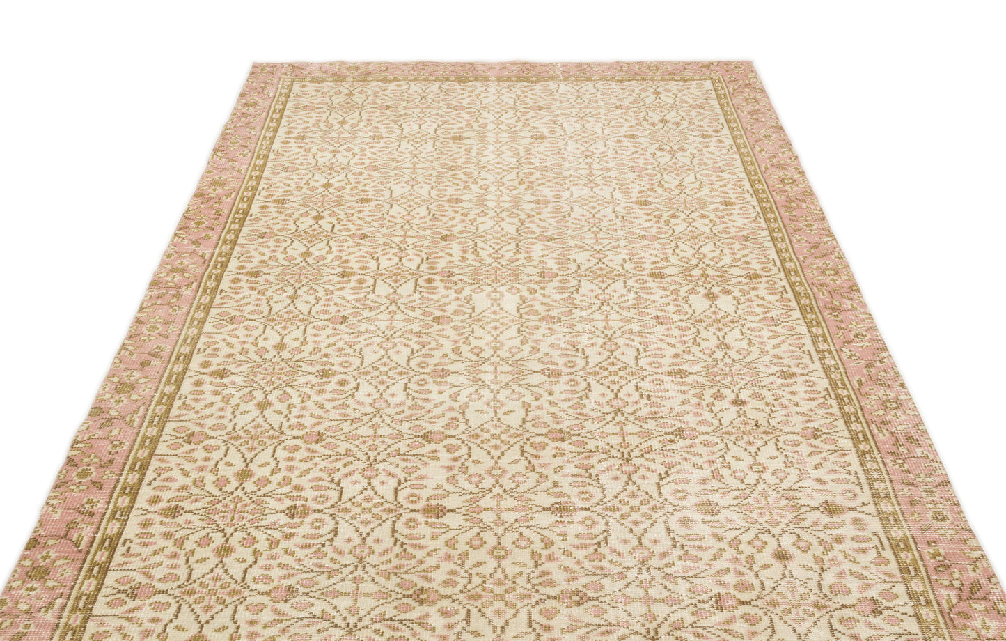 Cream, pink, and tan rug with an intricate floral medallion pattern and a wide decorative border.