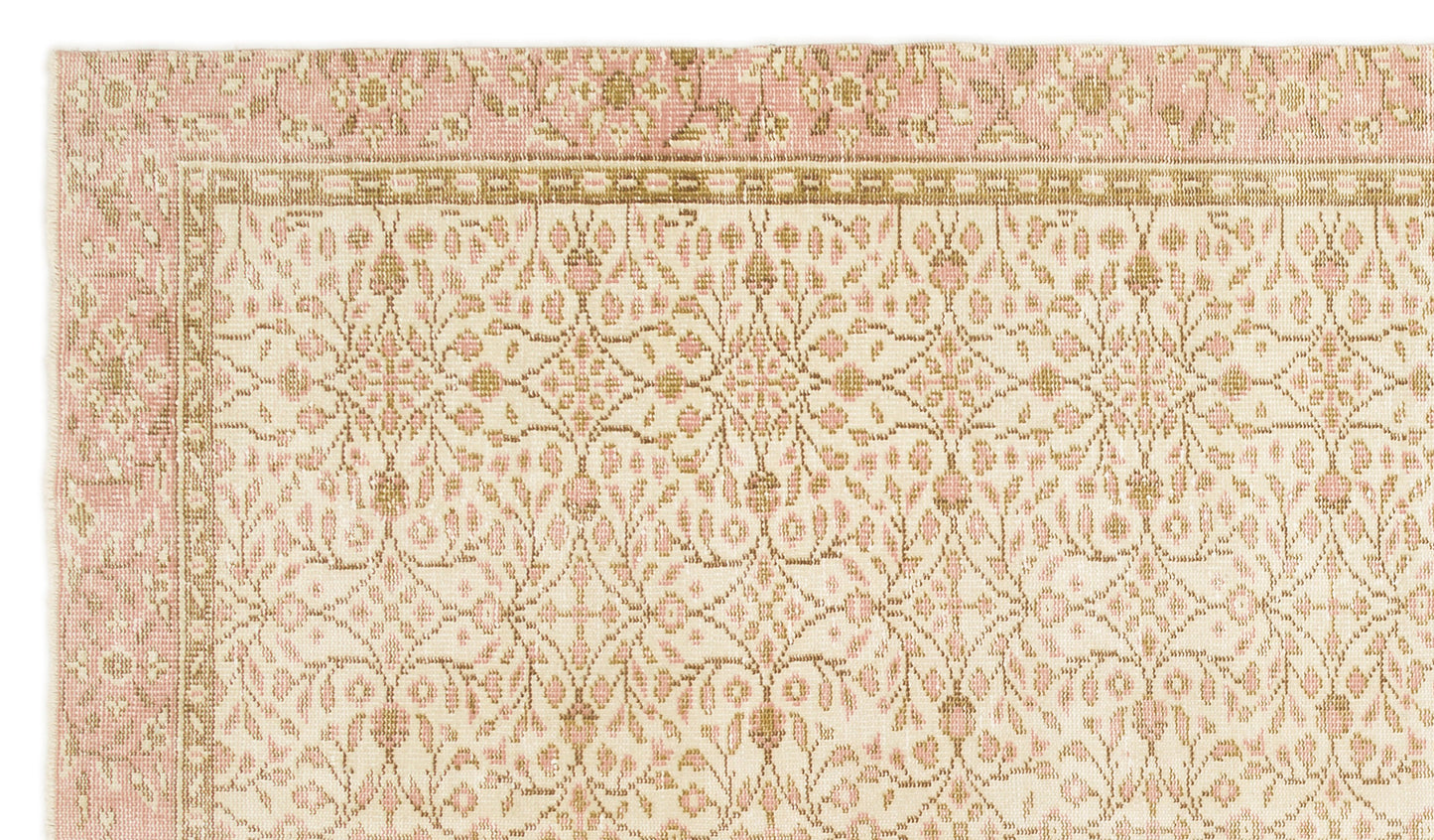 Cream and pink rug with a repeating floral medallion pattern and a geometric border.