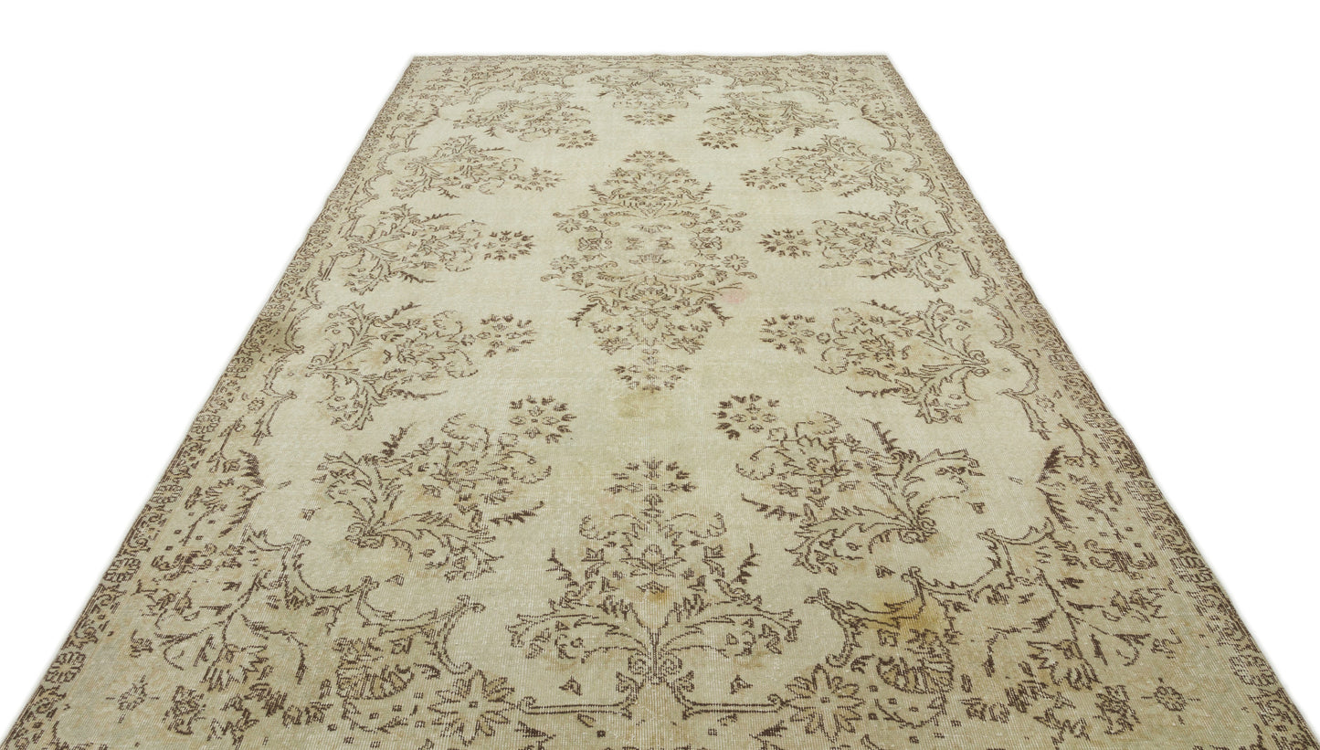 Cream and beige vintage-style rug with a distressed floral medallion pattern on a white background.
