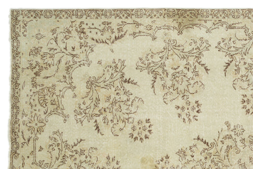 Load image 1 in gallery view. Beige and brown vintage-style rug with a distressed floral pattern and a decorative border.
