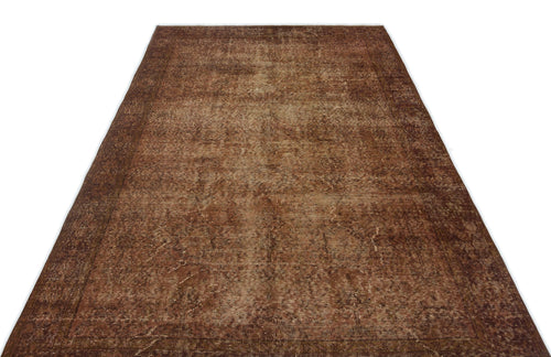 Load image 1 in gallery view. Distressed brown vintage-style rug with a faded traditional border and central medallion pattern on a white background.