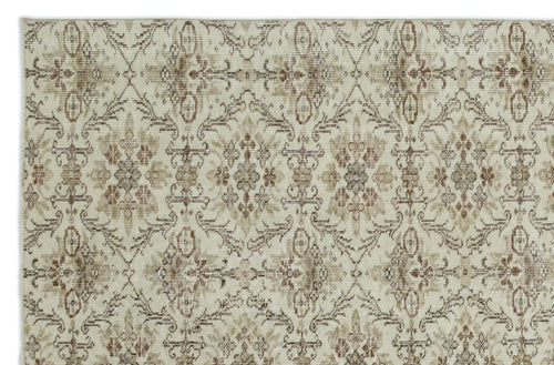 Load image 1 in gallery view. Beige and brown rug with a repeating distressed floral medallion pattern on a white background.