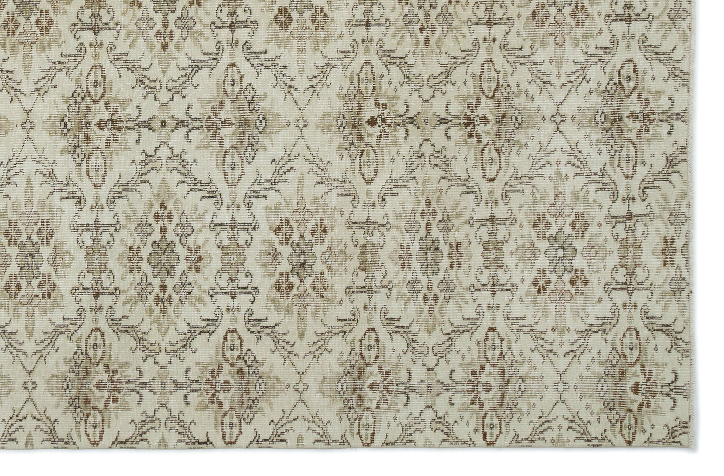 Beige and brown rug with a distressed, repeating floral medallion pattern on a cream background.