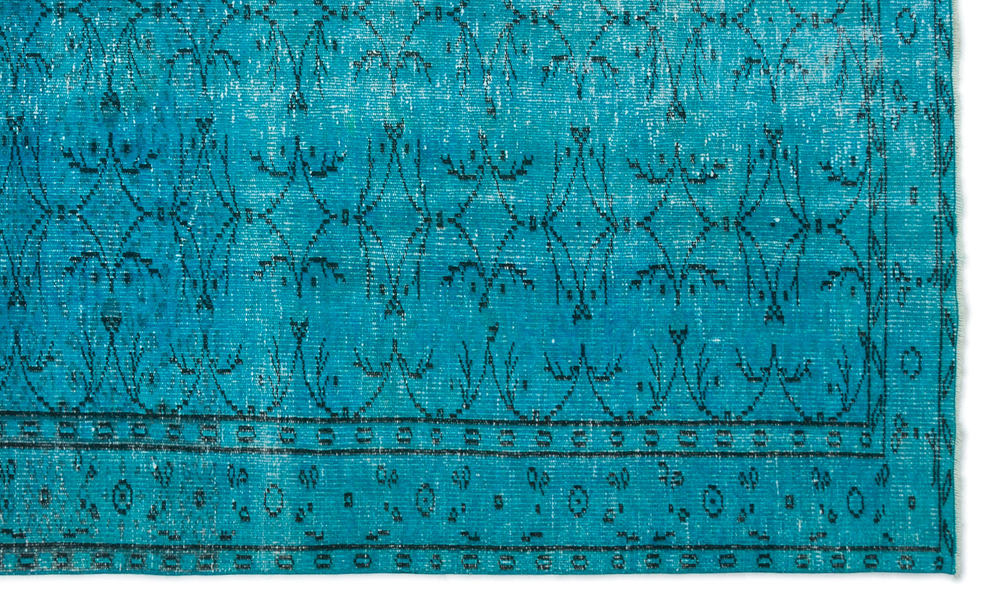 Bright turquoise rug with a distressed black geometric floral pattern and a bordered edge.