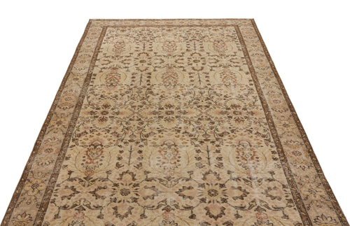 Load image 1 in gallery view. Beige and brown vintage-style rug with a distressed floral medallion pattern and a decorative border.