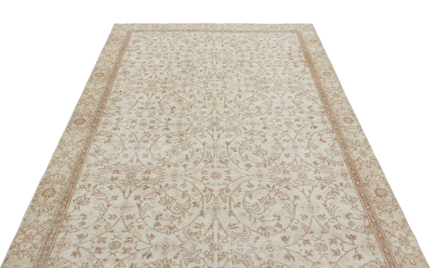 Beige and cream vintage-style rug with a symmetrical floral medallion pattern and a decorative border.