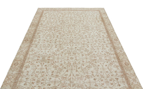 Load image 1 in gallery view. Beige and cream vintage-style rug with a symmetrical floral medallion pattern and a decorative border.