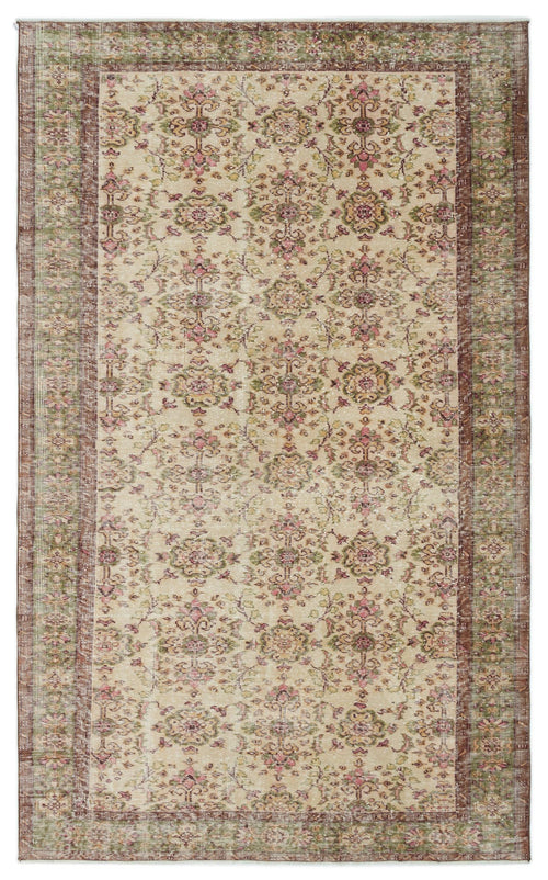 Load image 1 in gallery view. Beige vintage-style rug with a distressed floral medallion pattern in muted pink, green, and brown tones.