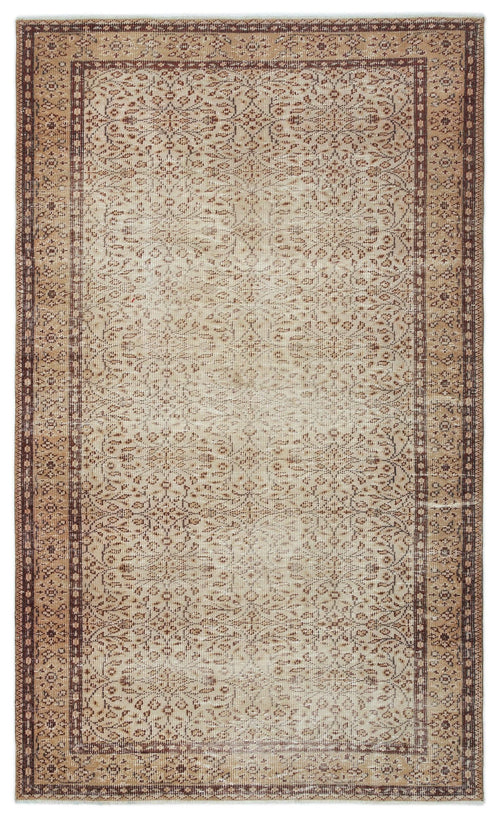 Load image 1 in gallery view. Tan and brown vintage-style rug with a distressed floral pattern and a decorative geometric border.