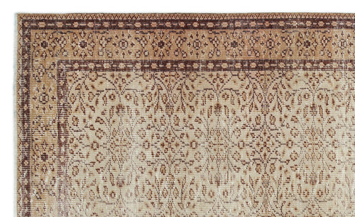 Load image 1 in gallery view. Tan and brown vintage-style rug with a traditional floral medallion pattern and a detailed geometric border.