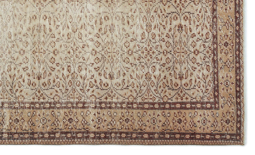 Load image 1 in gallery view. Beige and brown vintage-style rug with a distressed floral medallion pattern and a geometric border.