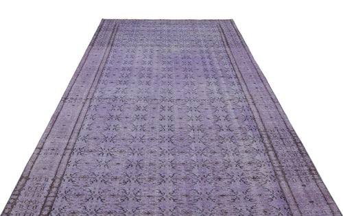 Load image 1 in gallery view. Distressed purple vintage-style rug with a repeating dark grey floral medallion pattern and a bordered edge.