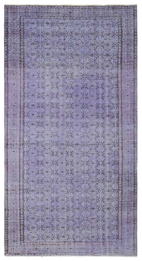 Load image 1 in gallery view. Lavender and dark grey distressed rug with a repeating floral medallion pattern and a bordered edge.