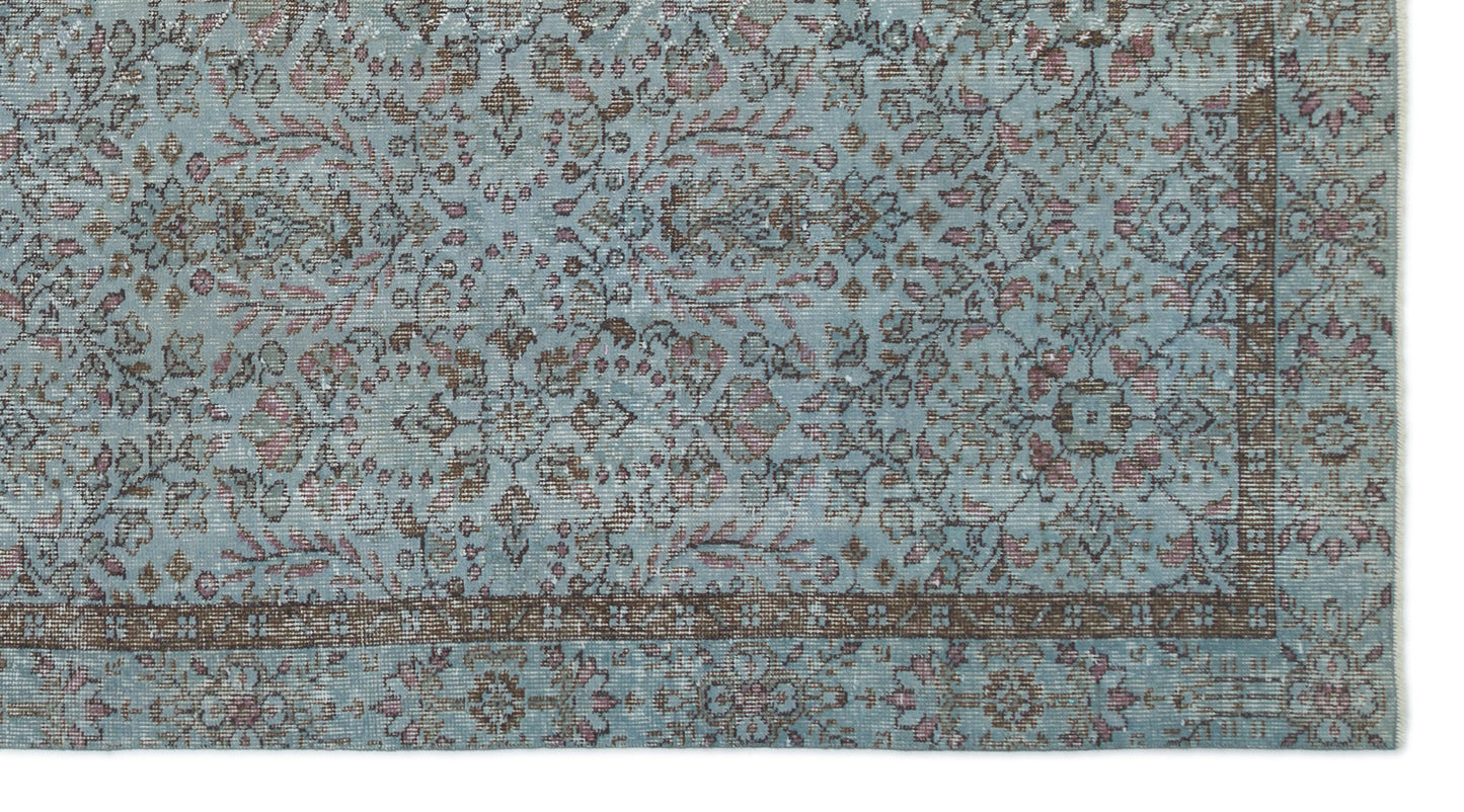 Light blue traditional rug with a distressed floral pattern in brown and muted pink, featuring a dark border.