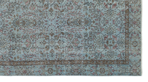 Load image 1 in gallery view. Light blue traditional rug with a distressed floral pattern in brown and muted pink, featuring a dark border.