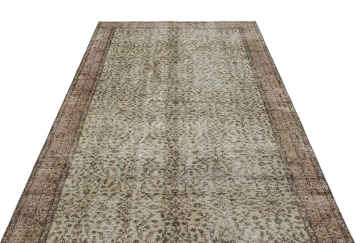 Load image 1 in gallery view. Distressed beige and brown vintage-style rug with an intricate floral pattern and a wide decorative border.