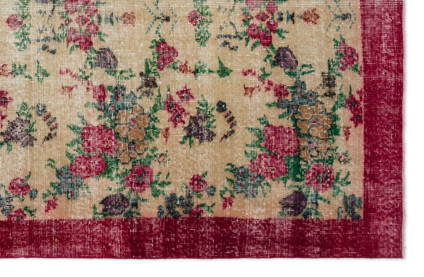 Beige vintage-style rug with a distressed floral pattern in red, green, and purple, featuring a solid red border.