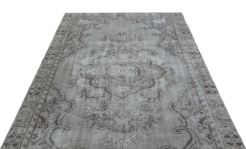 Load image 1 in gallery view. Grey and brown distressed vintage-style rug with a central floral medallion and ornate border.