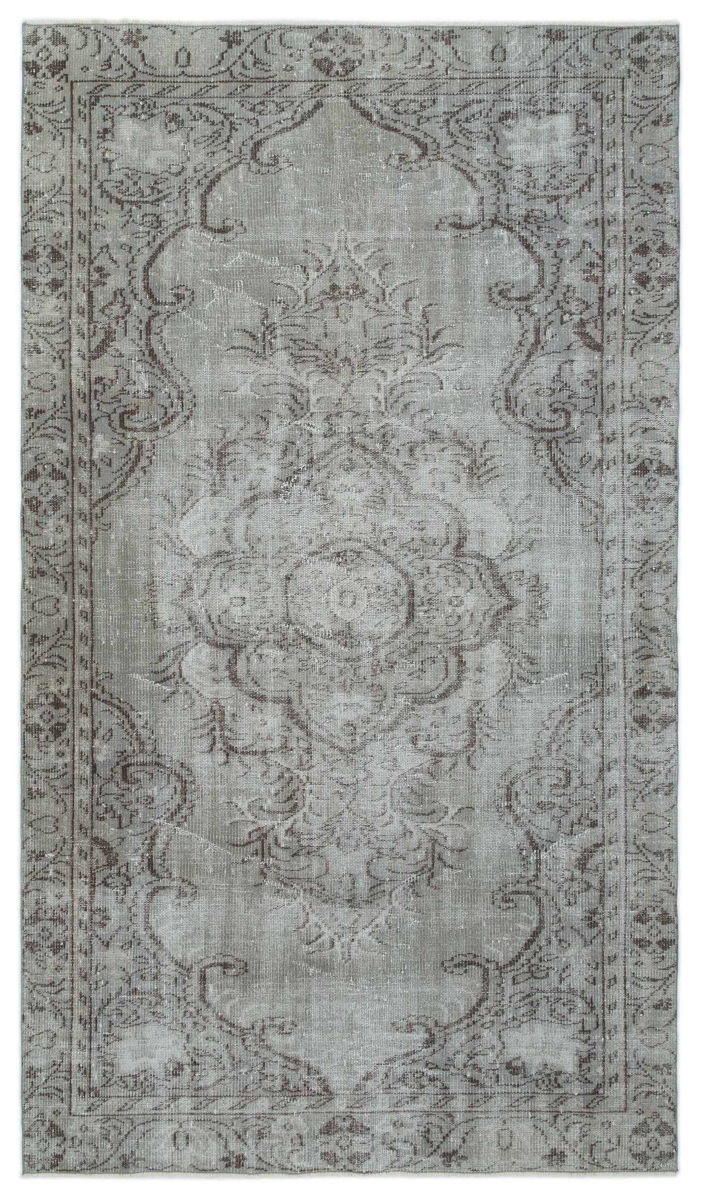 Grey and taupe distressed traditional rug with a central floral medallion and ornate border pattern.
