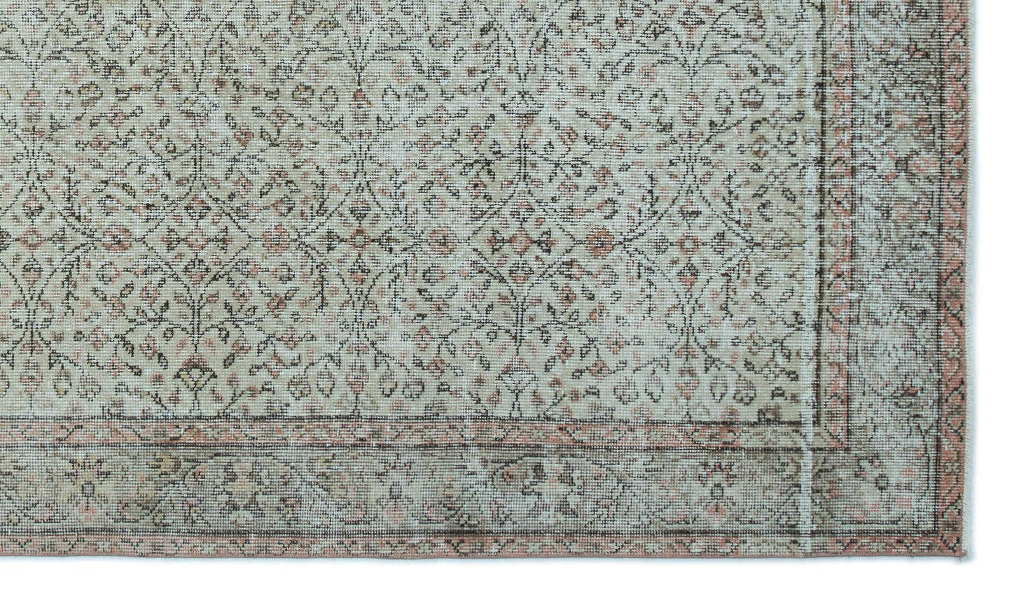 Distressed beige and grey rug with a faded floral trellis pattern and a muted terracotta border.