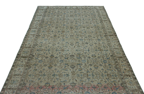 Load image 1 in gallery view. Beige vintage-style rug with a faded floral pattern in blue and brown, featuring a decorative border.