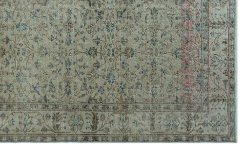 Load image 1 in gallery view. Beige vintage-style rug with a distressed floral medallion pattern in blue, brown, and muted red accents.