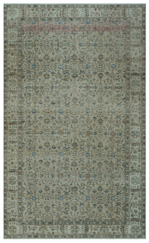 Load image 1 in gallery view. Distressed beige rug with a faded floral medallion pattern in blue and brown, featuring a decorative border.