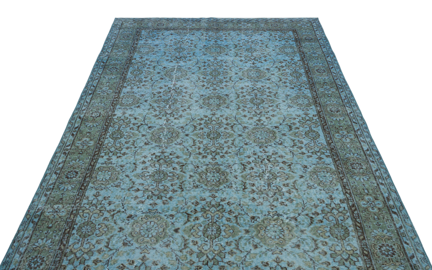 Light blue and sage green distressed rug with a traditional floral medallion pattern and a dark border.