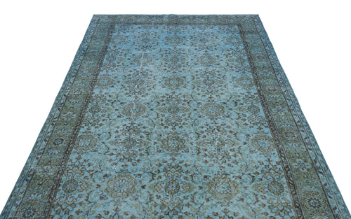 Load image 1 in gallery view. Light blue and sage green distressed rug with a traditional floral medallion pattern and a dark border.
