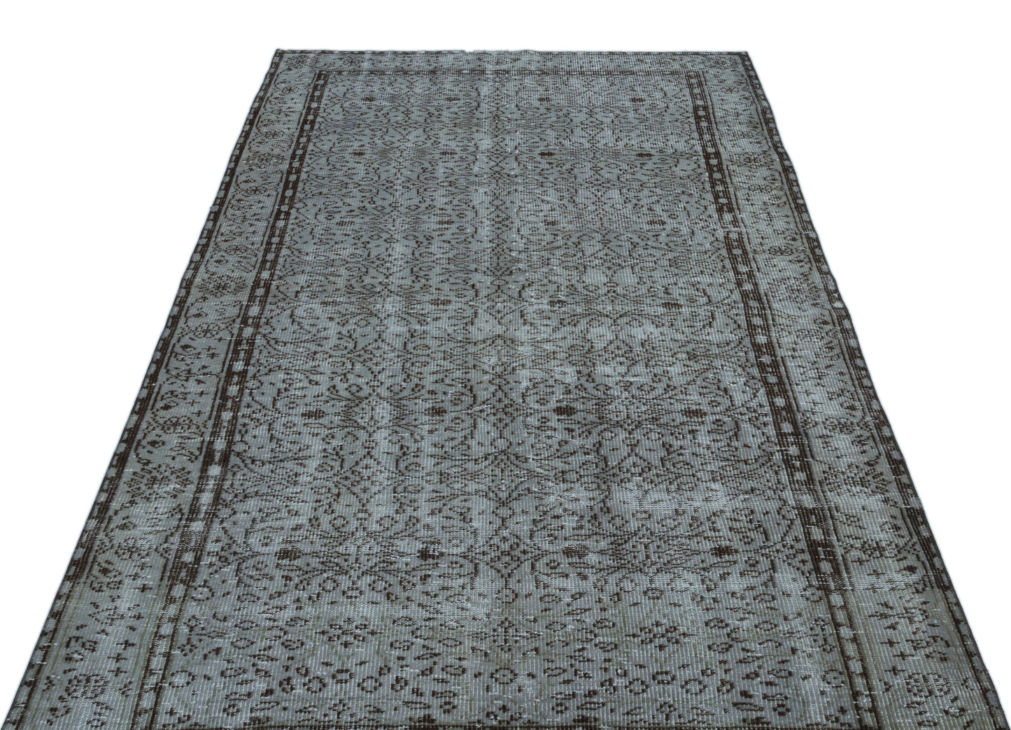 Grey and dark brown distressed rug with an intricate traditional floral pattern and a bordered edge.