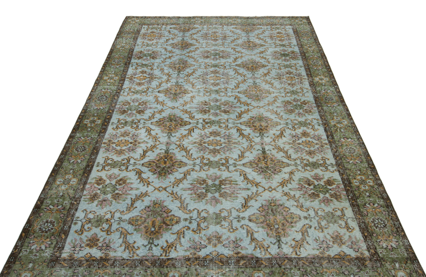 Light blue vintage-style rug with a repeating floral medallion pattern and a dark green and brown border.