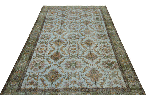 Load image 1 in gallery view. Light blue vintage-style rug with a repeating floral medallion pattern and a dark green and brown border.