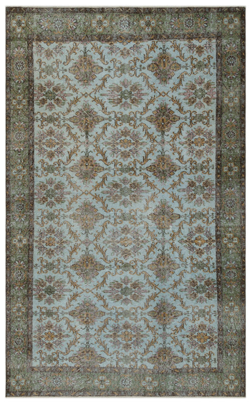Load image 1 in gallery view. Light blue traditional rug with a distressed floral medallion pattern and a dark green and brown border.