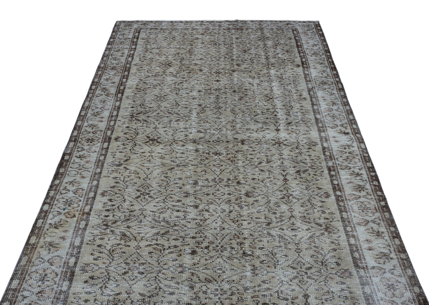 Beige and brown vintage-style rug with a distressed floral medallion pattern and a decorative border.