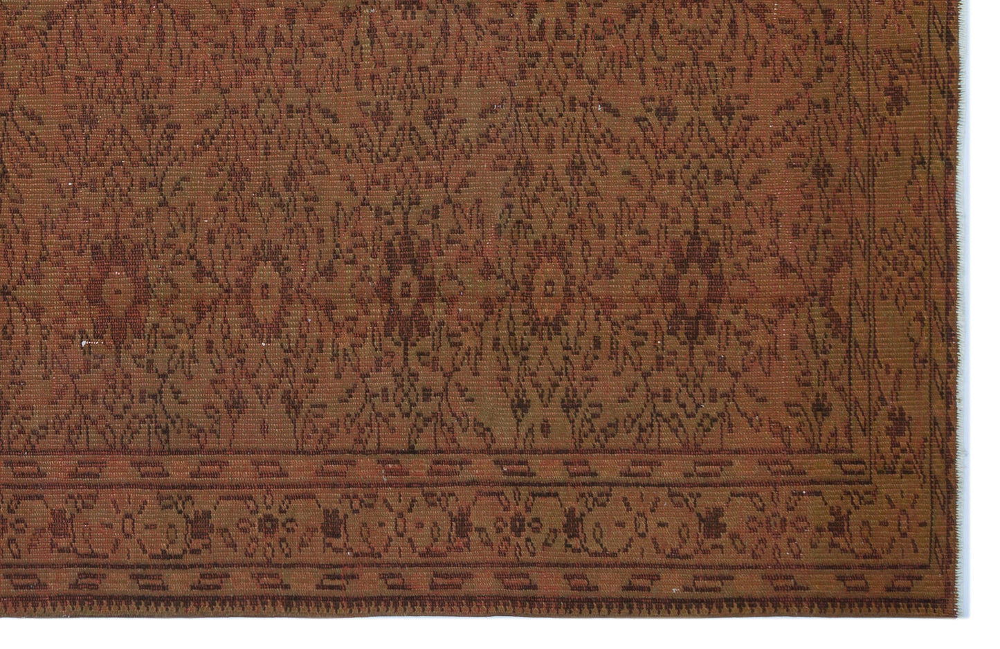 Rust and brown traditional rug with a repeating floral medallion pattern and a geometric border.