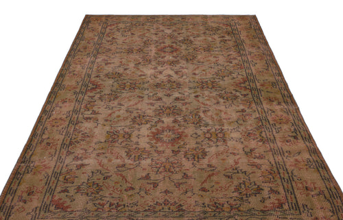Load image 1 in gallery view. Distressed brown and rust-toned traditional rug with a faded floral medallion pattern and a geometric border.