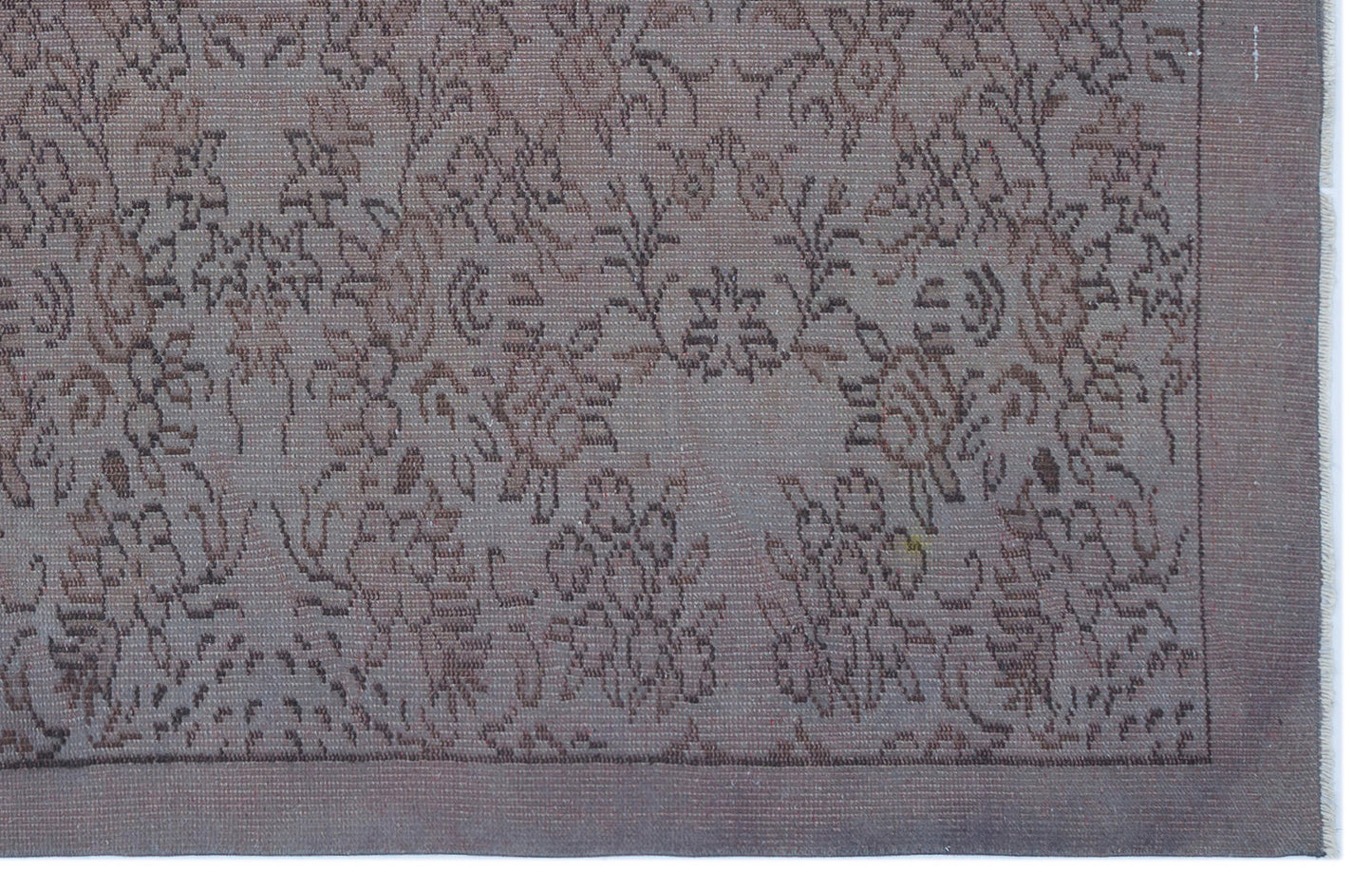Muted mauve and brown rug with a traditional floral medallion pattern and a solid border.