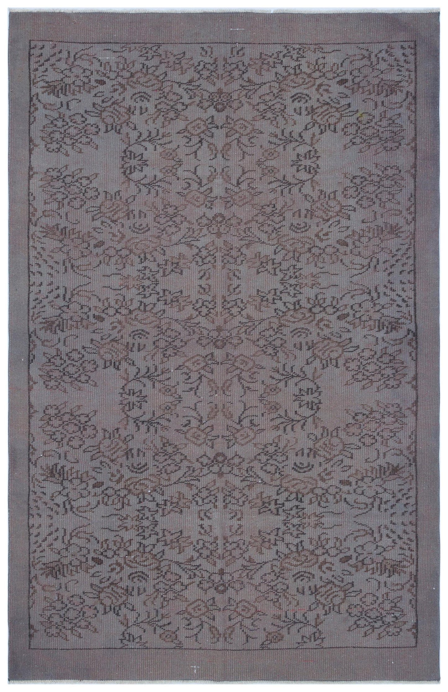 Grey and brown vintage-style rug with a symmetrical floral medallion pattern and a solid border.