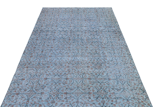 Load image 1 in gallery view. Light blue distressed rug with a dark grey and rust-colored repeating floral medallion pattern.