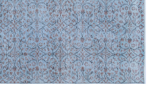 Load image 1 in gallery view. Light blue rug with a distressed floral medallion pattern in muted rust and charcoal grey.